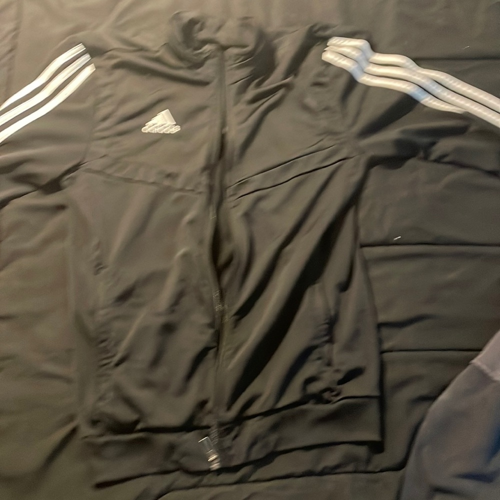 Adidas zip up sweater with stripes on arms.